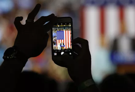 An attendee shoots a photo on a cell phone of Democratic U.S vice presidential candidate Senator Tim Kaine speaking as he appears with Democratic U.S. presidential candidate Hillary Clinton during a campaign rally in Miami, Florida, U.S. July 23, 2016.