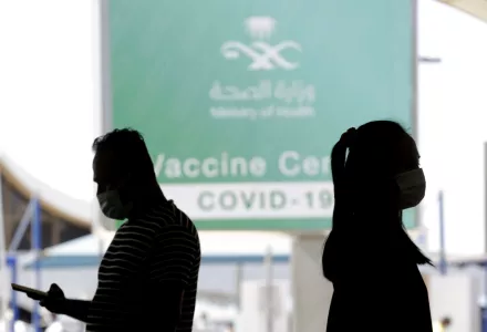 People walk outside a coronavirus vaccine center at the old Jiddah airport, Saudi Arabia, Tuesday, May 18, 2021