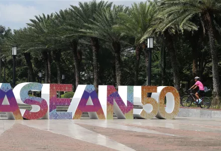 A cyclist pedals past an ASEAN logo, Monday, November 6, 2017, Pasay City, Philippines.