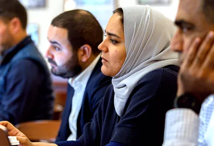 Students in a row listening to a speaker at a study group session.
