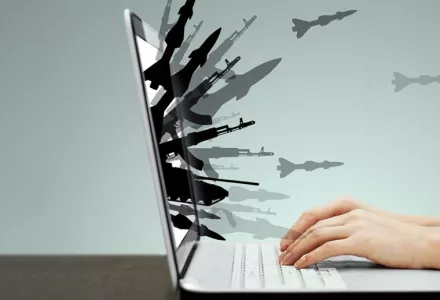 guns and missiles burst forth from a laptop screen
