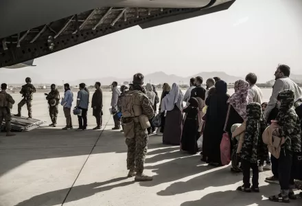 In this image provided by the U.S. Marine Corps, evacuees wait to board a Boeing C-17 Globemaster III during an evacuation at Hamid Karzai International Airport in Kabul, Afghanistan, Monday, Aug. 30. 2021.