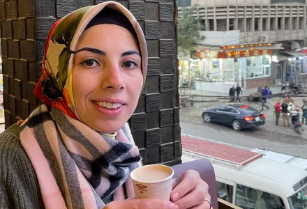 Marsin Alshamary enjoying a coffee on a balcony in Baghdad, Iraq.