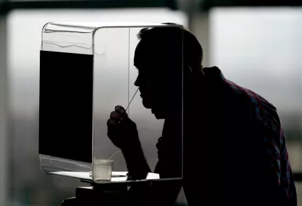 man takes a rapid COVID-19 test