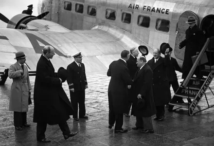 British Foreign Minister Lord Edward Halifax, left, British Prime Minister Neville Chamberlain, back to camera, shaking hands with French Prime Minister Edouard Daladier.