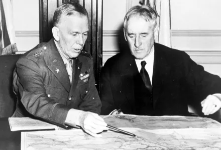 George C. Marshall, Chief of staff, and Henry L. Stimson, Secretary of War, confer over a map in the War Department