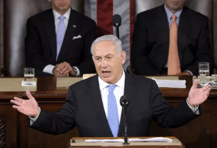 Israeli Prime Minister Benjamin Netanyahu gestures while addressing a joint meeting of Congress on Capitol Hill in Washington, Tuesday, May 24, 2011. Vice President Joe Biden, left, and House Speaker John Boehner of Ohio, right, listen.