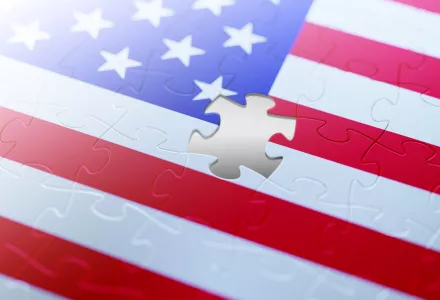 An illustration of the American flag with a jigsaw puzzle piece missing.