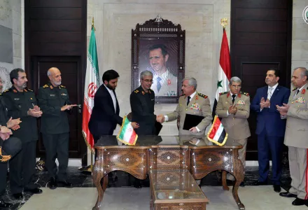 Chief of Staff of Iran's armed forces, Maj. Gen. Mohammad Bagheri, center left, shakes hands with his Syrian counterpart Gen. Ali Ayoub, center right, during a ceremony to sign a joint memorandum of understanding for developing cooperation and coordination between the two countries' armies in Damascus