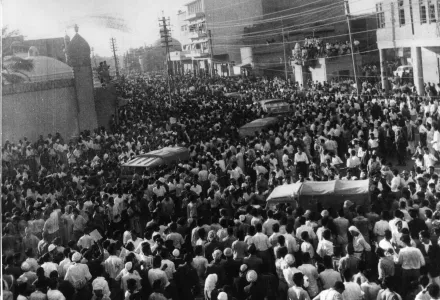 Military vehicles move slowly through the crowded streets in Baghdad, Iraq, July 14, 1958.