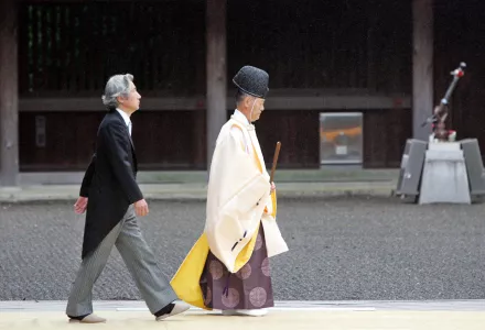 Japanese Prime Minister Junichiro Koizumi follows a Shinto priest toward the sanctuary of the Yasukuni war shrine