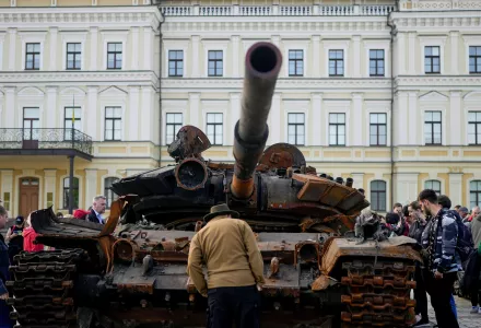 A man looks at a destroyed Russian tank placed as a symbol of war in downtown Kyiv, Ukraine