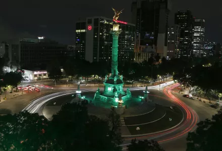 Angel of Independence monument, lit up in green in Mexico City