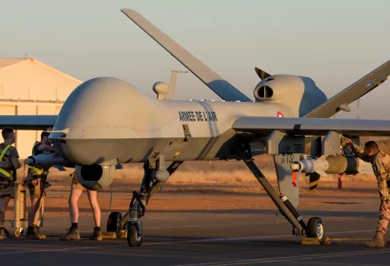 French soldiers loading a French Reaper drone with two GBU 12 missiles