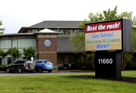 a sign stands advertising school vaccines and physical exams  sits in front of the Knox County Health Department in Mount Vernon, Ohio