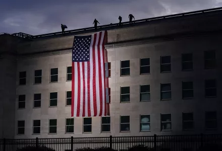 A large American flag is unfurled at the Pentagon