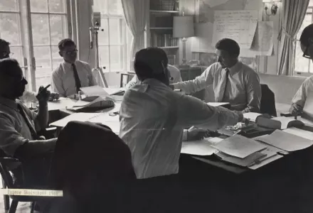 Wargame participants seated around a table