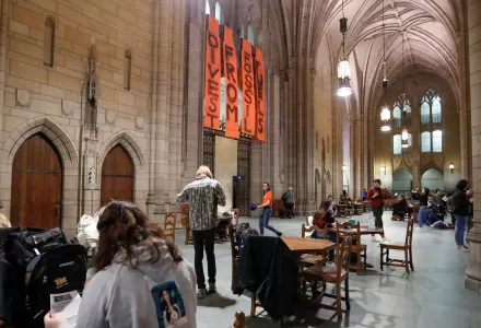 Students at left watch as student activists take positions in the Cathedral of Learning