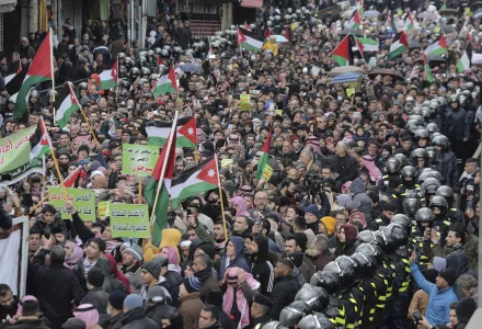 Protesters carry Jordanian and Palestinian flags and slogans during a protest against the Middle East peace plan proposed by U.S. President Donald Trump, in the center of Amman, Jordan, Friday, Jan. 31, 2020. 