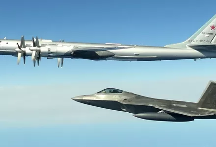A Russian Tu-95 bomber, top, is intercepted by a U.S. F-22 Raptor off the coast of Alaska in this photo taken June 16, 2020. (North American Aerospace Defense Command via AP)