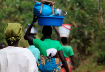 People walk back from a market
