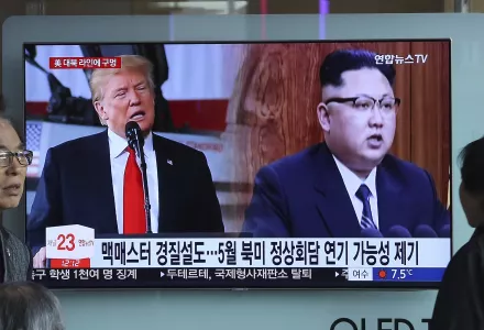 A TV screen shows North Korean leader Kim Jong Un, right, and U.S. President Donald Trump during a news program