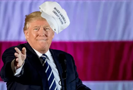 Donald Trump throws a hat into the audience 