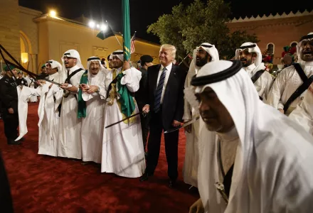 President Donald Trump holds a sword and sways with traditional dancers during a welcome ceremony at Murabba Palace in Riyadh