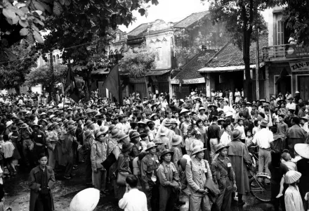 Viet Minh troops are surrounded by civilians as they enter Hanoi 