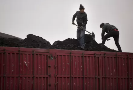 Workers shovel coal atop a trailer truck at a coal mine near Ordos in northern China’s Inner Mongolia Autonomous Region.