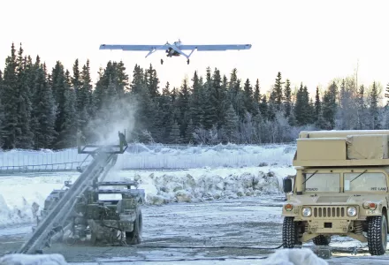 An RQ7 Shadow unmanned aircraft flies from its pneumatic catapult launcher.