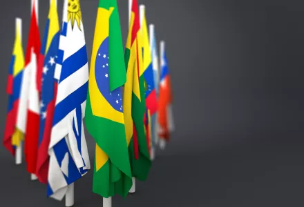 Flags grouped together in front of a gray background