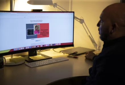 Desta Haileselassie sits at his desk 