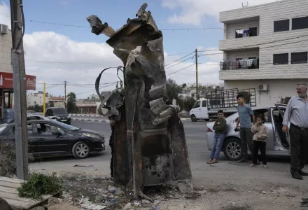 Palestinians inspect the debris of an Iranian missile intercepted by Israel, in the West Bank city of Hebron, Oct. 2, 2024. (AP Photo/Mahmoud Illean)