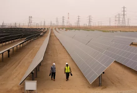 Engineers walk next to solar panels at Benban Solar Park in Aswan, Egypt.