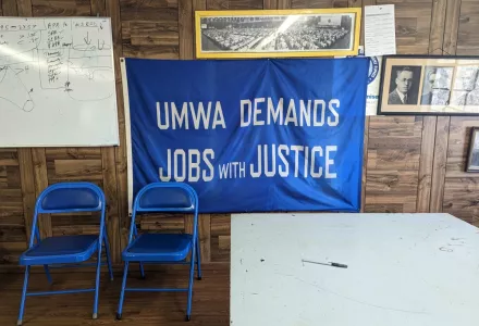 A banner bearing the slogan “UMWA demands jobs with justice” hangs on the wall at the United Mine Workers of America career center in Beckley, West Virginia.