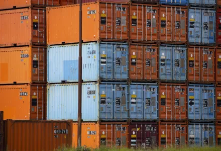 Orange and blue shipping containers in the port of Rotterdam, Netherlands.