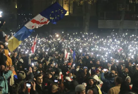 Demonstrators stand in front of police during a rally