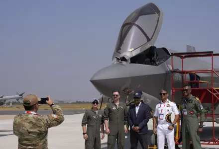 Indian naval officers, right, pose with the U.S. Air Force officers in front of the F-35 fighter aircraft at Yelahanka air base in Bengaluru, India, Friday, Feb. 14, 2025