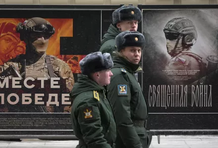 A military patrol passes by a street exhibition of military posters named 'Together to Victory' dedicated to Russian army in St. Petersburg, Russia, Monday, Feb. 24, 2025.