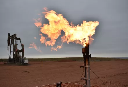 A flare burns natural gas at an oil well in Watford City, N.D., Aug. 26, 2021.