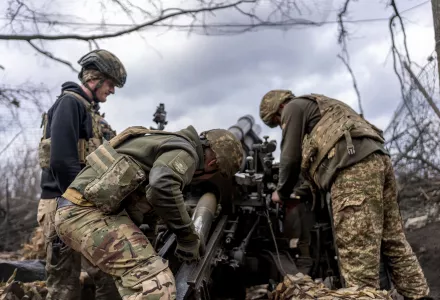 Ukrainian servicemen of Khartia brigade loading shell into M101 Howitzer before firing towards Russian positions in Kharkiv region, Ukraine, Wednesday, March 12, 2025. (AP Photo/Alex Babenko)