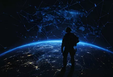 Silhouette of a soldier standing on the Earth with a blue, glowing world map in the background, connecting lines between cities and a global network connection.