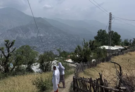 Villager women walk on a dusty track during a government's organized trip for media to Bella Noor Shah, a mountainous village near Muzaffarabad, the capital of Pakistan administered Kashmir, Monday, May 5, 2025. 