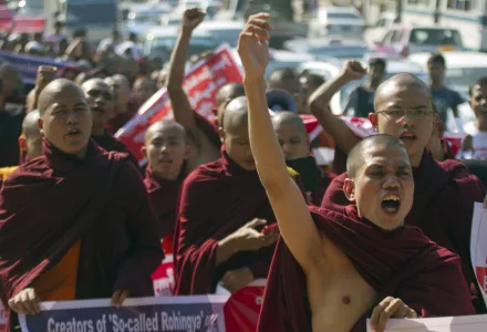 In this Friday, Jan. 16, 2015 file photo, Myanmar Buddhist monks shout slogans as they march to protest against a resolution adopted by the UN General Assembly calling on Myanmar to grant citizenship to Rohingya in Yangon, Myanmar.