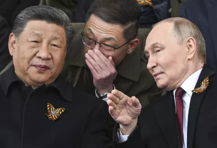 Russian President Vladimir Putin, right, and Chinese President Xi Jinping, left, talk as they watch the Victory Day military parade in Moscow, Russia, Friday, May 9, 2025.