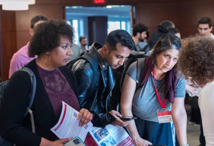 Students speaking with a member of the Belfer team during the 2024 Open House