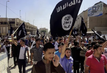 Demonstrators chant pro-Islamic State group slogans as they wave the group's flags in front of the provincial government headquarters in Mosul, 225 miles (360 kilometers) northwest of Baghdad, Iraq, Monday, June 16, 2014. 
