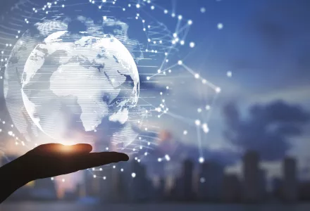 A hand beneath a glowing stylized version of the globe