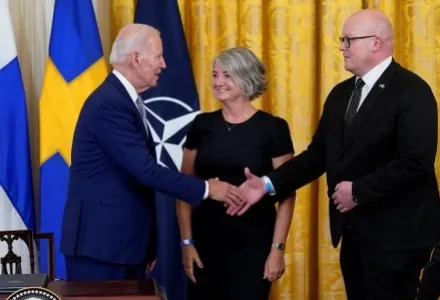President Joe Biden shakes hands with Mikko Hautala, Finland's ambassador to the U.S., as he speaks with Hautala and Karin Olofsdotter, Sweden's ambassador to the U.S.